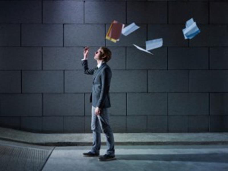 businessman throwing away files and documents